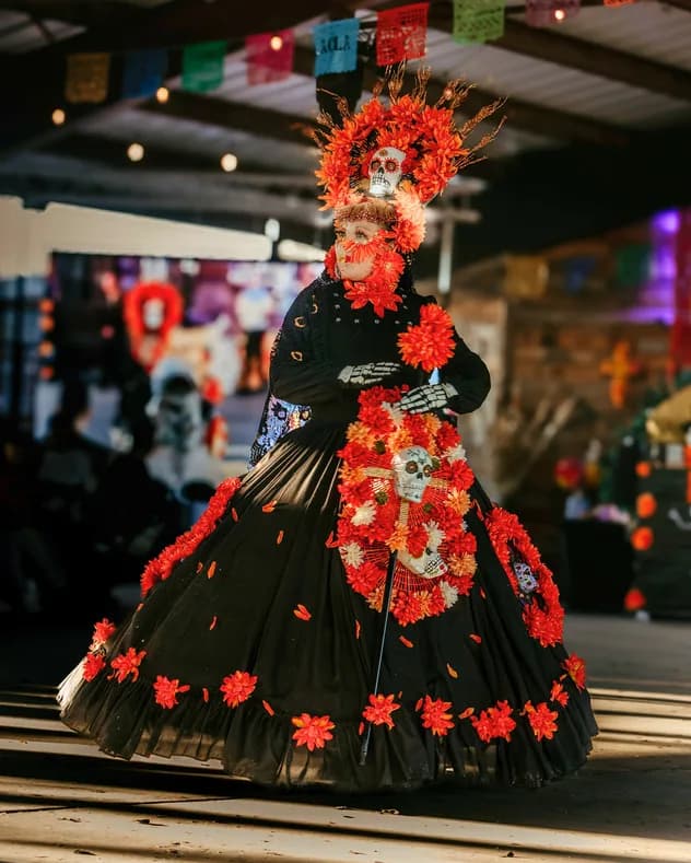 A Catrina crowned with orange marigolds