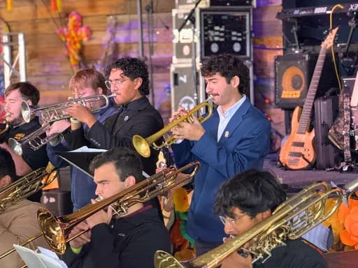 A mariachi band playing at dusk
